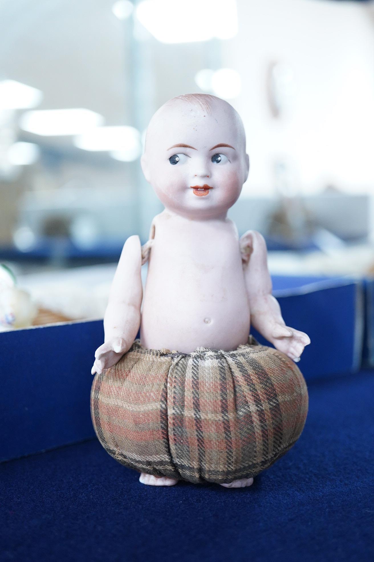 A collection of vintage porcelain half dolls and a bisque porcelain example with jointed limbs